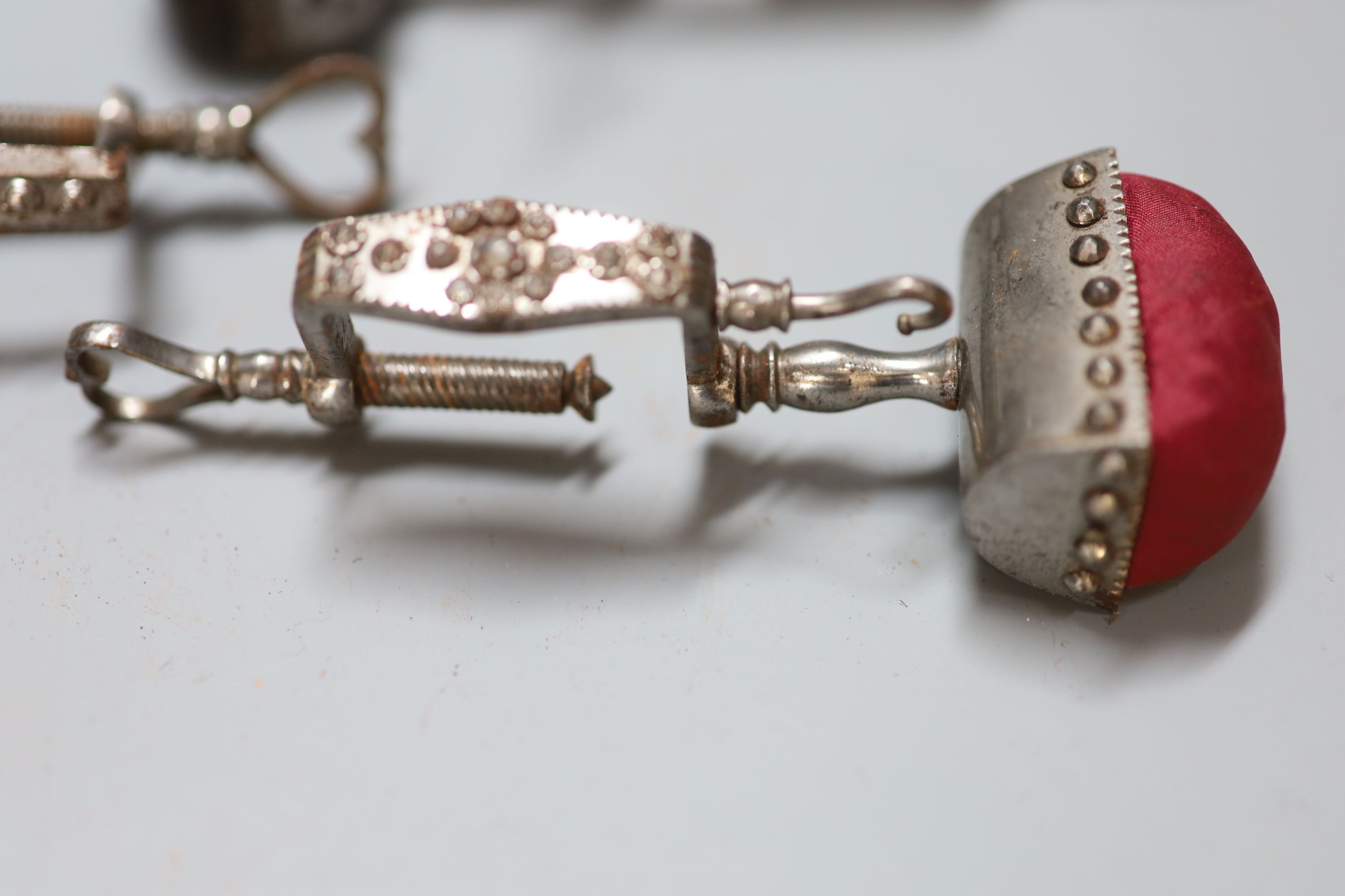 Four assorted early 19th century steel sewing clamps